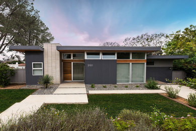 Inspiration for a mid-sized modern gray one-story mixed siding exterior home remodel in San Diego with a mixed material roof