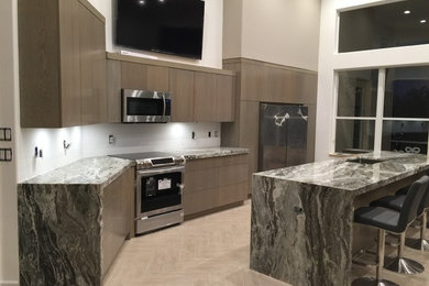 Large transitional single-wall eat-in kitchen in Miami with an undermount sink, flat-panel cabinets, medium wood cabinets, quartzite benchtops, stainless steel appliances, porcelain floors and with island.