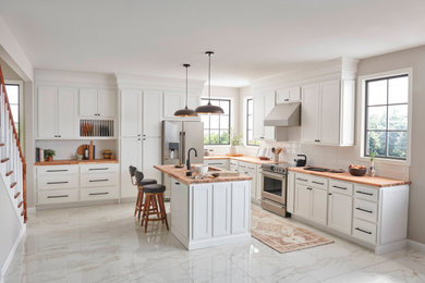 Transitional kitchen photo in Boston with white cabinets and wood countertops
