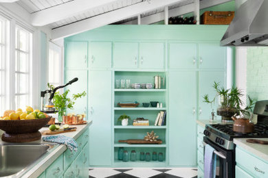 Inspiration for a coastal u-shaped multicolored floor, exposed beam and vaulted ceiling kitchen remodel in Baltimore with a drop-in sink, flat-panel cabinets, turquoise cabinets, laminate countertops, black appliances, no island and beige countertops
