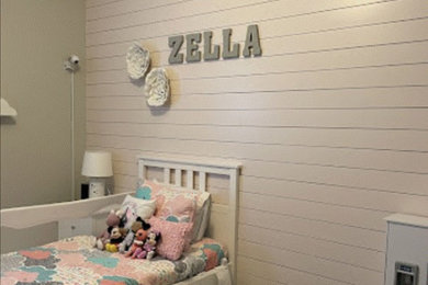 Example of a mid-sized farmhouse shiplap wall bedroom design in Other with pink walls
