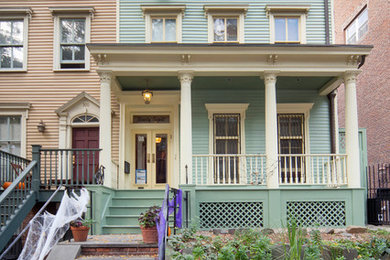 Inspiration for a timeless green three-story wood exterior home remodel in Salt Lake City with a mixed material roof