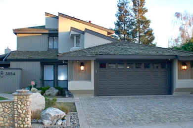 Large trendy beige two-story mixed siding house exterior photo in Other with a hip roof