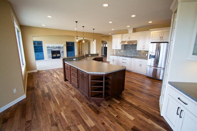 Open concept kitchen - huge open concept kitchen idea in Other with raised-panel cabinets, dark wood cabinets, solid surface countertops and an island