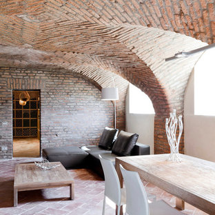 Design ideas for a large mediterranean look-out basement in Milan with brick flooring.