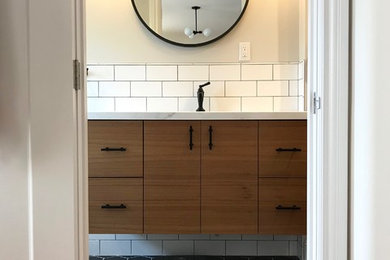 Small midcentury master bathroom in San Francisco with flat-panel cabinets, dark wood cabinets, an open shower, a wall-mount toilet, white tile, ceramic tile, beige walls, ceramic floors, an undermount sink, engineered quartz benchtops, black floor and a hinged shower door.