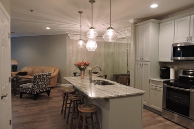 Example of a small transitional single-wall light wood floor and beige floor eat-in kitchen design in DC Metro with shaker cabinets, white cabinets, marble countertops, an island, an undermount sink and stainless steel appliances
