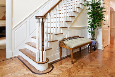 Example of a large transitional medium tone wood floor entryway design in New York with yellow walls