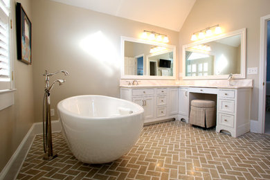 Mid-sized elegant master marble floor and beige floor freestanding bathtub photo in Charlotte with recessed-panel cabinets, white cabinets, an undermount sink and marble countertops