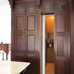 Large traditional kitchen pantry inspiration - Example of a large classic l-shaped bamboo floor kitchen pantry design in Ottawa with an undermount sink, raised-panel cabinets, dark wood cabinets, quartzite countertops, multicolored backsplash, mosaic tile backsplash, stainless steel appliances and an island