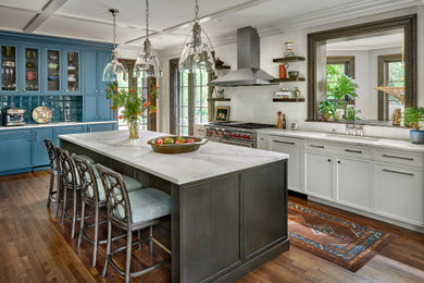 Eat-in kitchen - large transitional l-shaped dark wood floor, brown floor and coffered ceiling eat-in kitchen idea in Chicago with an undermount sink, shaker cabinets, white cabinets, white backsplash, porcelain backsplash, an island, white countertops and stainless steel appliances
