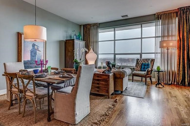 Mid-sized transitional medium tone wood floor great room photo in St Louis with gray walls and no fireplace