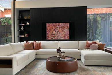 Inspiration for a large contemporary open concept living room in Melbourne with black walls.