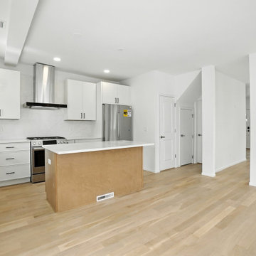 White Kitchen with Stone Counters and Gas Range