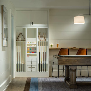Photo of a coastal basement in Boston with white walls and medium hardwood flooring.