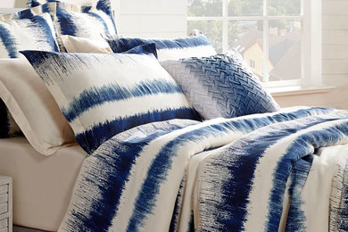 Example of a large country master bedroom design in Toronto with white walls and no fireplace