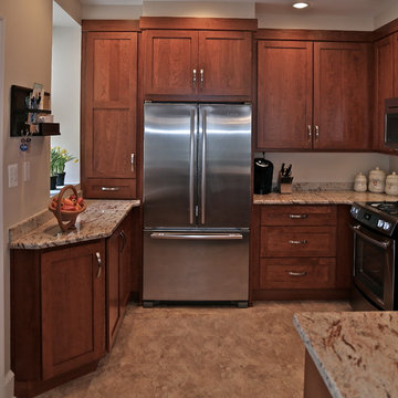 Warm Wood Kitchen Remodel | Angled Granite Island & Integrated Display Cabinets