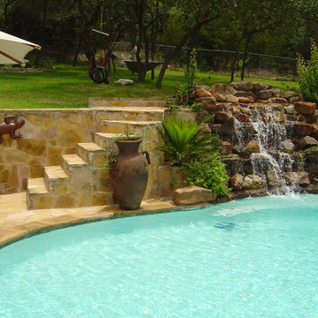Pool with Moss Rock Waterfall and Flagstone Deck
