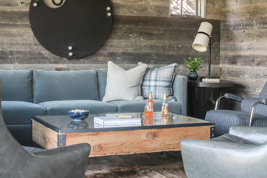 Mountain style brown floor family room photo in Other with gray walls