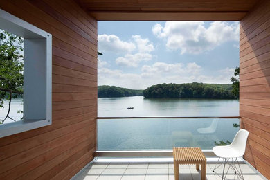 Balcony - small contemporary balcony idea in Cedar Rapids with a roof extension