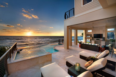 Hot tub - coastal tile and custom-shaped infinity hot tub idea in Miami
