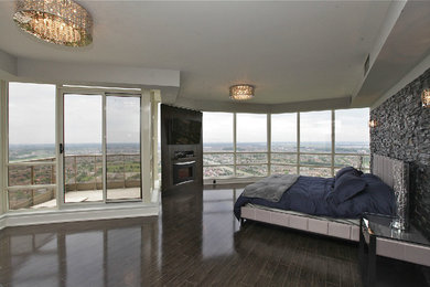 Large master dark wood floor bedroom photo in Toronto with a standard fireplace
