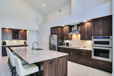 Eat-in kitchen - mid-sized transitional l-shaped eat-in kitchen idea in Tampa with shaker cabinets, brown cabinets, quartzite countertops, stainless steel appliances and an island