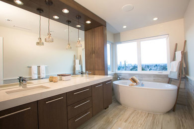 Trendy master beige tile and porcelain tile porcelain tile freestanding bathtub photo in Vancouver with an undermount sink, flat-panel cabinets, dark wood cabinets, quartz countertops and white walls