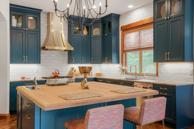 Open concept kitchen - large transitional u-shaped exposed beam open concept kitchen idea in Denver with an undermount sink, recessed-panel cabinets, blue cabinets, wood countertops, white backsplash, stainless steel appliances and an island