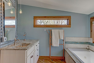 Bathroom - mid-sized farmhouse master medium tone wood floor and brown floor bathroom idea in Denver with shaker cabinets, white cabinets, a two-piece toilet, blue walls, an undermount sink and granite countertops