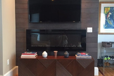 Mid-sized trendy open concept light wood floor and beige floor living room photo in Boston with beige walls, a ribbon fireplace, a metal fireplace and a wall-mounted tv