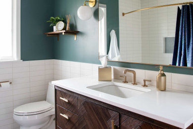 Mid-sized minimalist 3/4 white tile and ceramic tile cement tile floor, multicolored floor, single-sink and wainscoting bathroom photo in Minneapolis with flat-panel cabinets, distressed cabinets, a one-piece toilet, green walls, a drop-in sink, quartz countertops, white countertops and a freestanding vanity