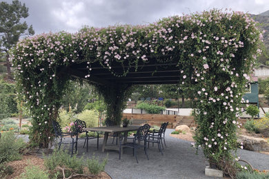 Huge tuscan backyard decomposed granite patio fountain photo in Los Angeles with a pergola