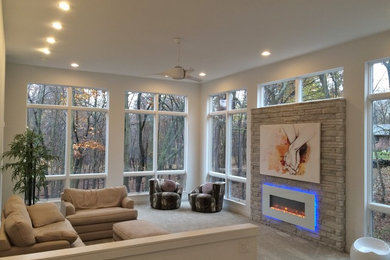 Living room - huge modern enclosed carpeted living room idea in Other with white walls, a standard fireplace and a brick fireplace