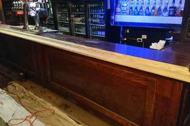 Inspiration for a large victorian galley seated home bar remodel in Toronto with wood countertops