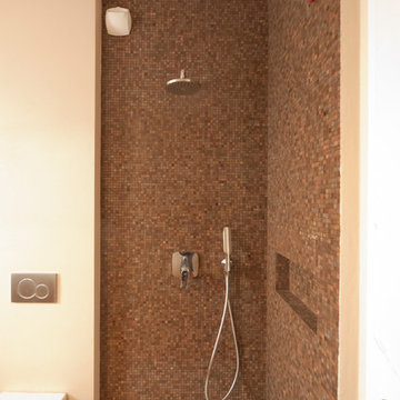 Neutral colors bathroom with glass mosaic tiles shower