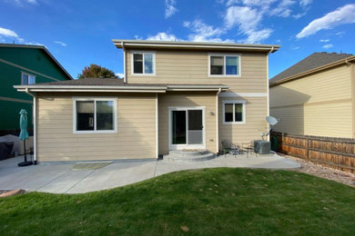 Large minimalist one-story vinyl house exterior photo in Denver with a shed roof, a shingle roof and a gray roof