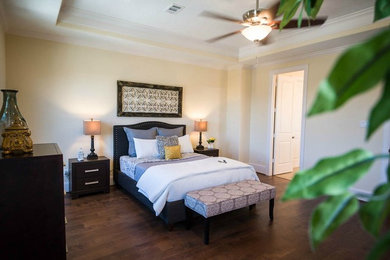 This is an example of a traditional bedroom in Houston with dark hardwood floors.