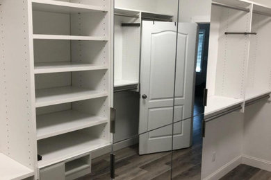Example of a closet design with white cabinets
