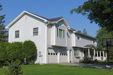 Example of a mid-sized trendy home design design in Burlington