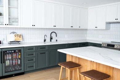 Kitchen photo in San Francisco with white backsplash and white countertops