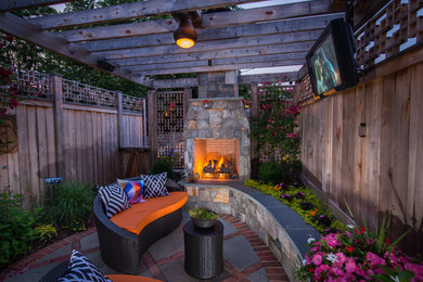 Mid-sized contemporary backyard patio in DC Metro with a fire feature and a pergola.