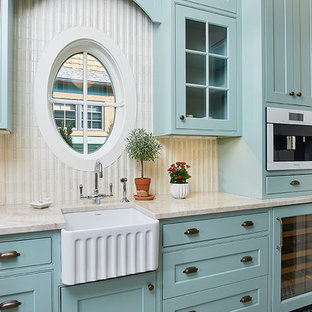This is an example of a large transitional single-wall kitchen pantry in Grand Rapids with a farmhouse sink, flat-panel cabinets, blue cabinets, granite benchtops, white splashback, ceramic splashback, panelled appliances, ceramic floors, no island, multi-coloured floor and multi-coloured benchtop.
