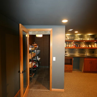 Design ideas for a medium sized contemporary fully buried basement in Milwaukee with black walls, carpet, a standard fireplace and a brick fireplace surround.