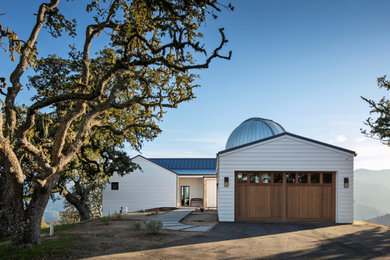 Inspiration for a mid-sized modern one-story house exterior remodel in Other with a metal roof
