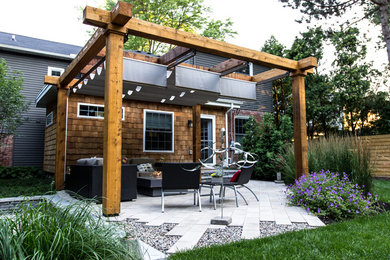 Inspiration for a mid-sized contemporary brown two-story mixed siding exterior home remodel in Detroit with a shingle roof