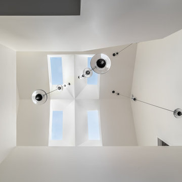 Pendant lights under skylight in the day.