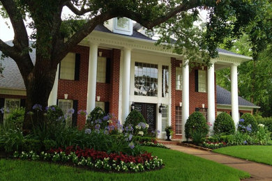 Photo of a large traditional partial sun front yard stone landscaping in Houston for spring.