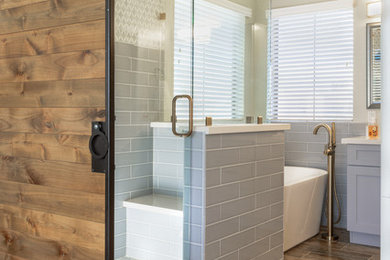 Inspiration for a large transitional master gray tile and subway tile dark wood floor and brown floor bathroom remodel in Phoenix with shaker cabinets, gray cabinets, marble countertops, beige walls, an undermount sink and a hinged shower door