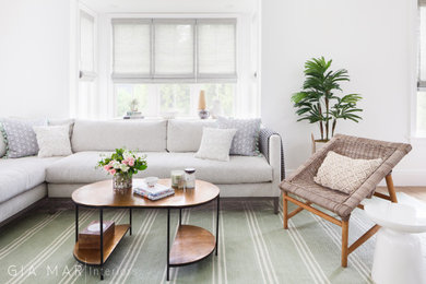 Inspiration for a huge coastal light wood floor living room remodel in New York with a two-sided fireplace and a stone fireplace